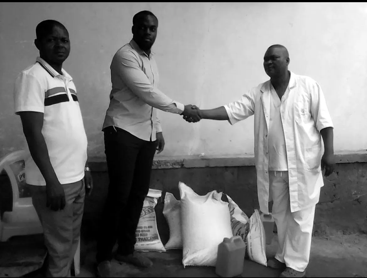 A team member shaking hands with clinic staff after a delivery
